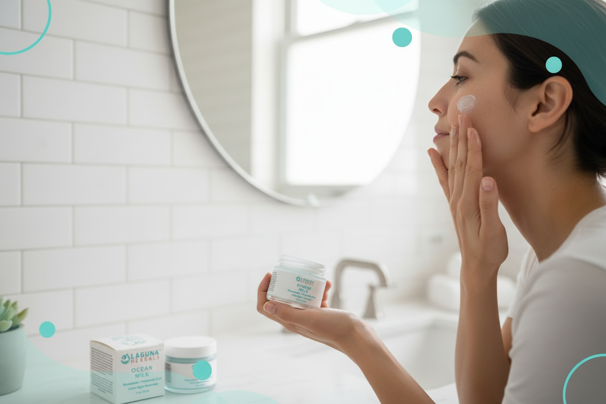 Woman applying cream to her face in a bathroom setting with L'ANNA products visible.