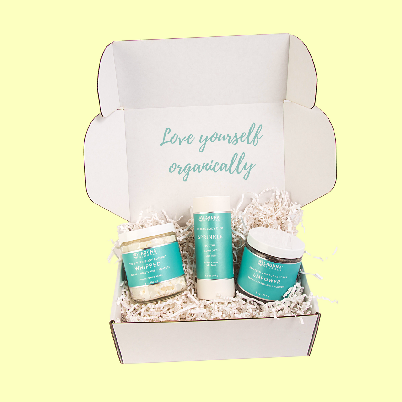 Three skincare products in a box with 'Love yourself organically' text on a light yellow background