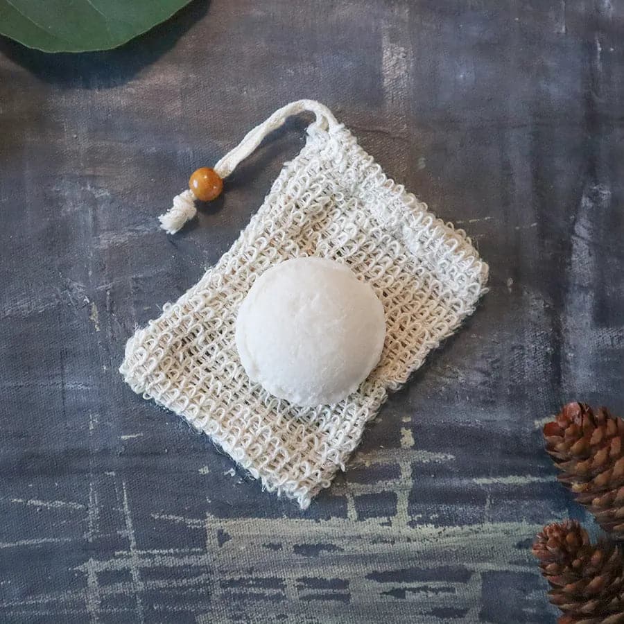 White bath bomb on a textured cloth with a dark background